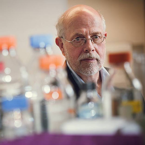 man in suit looking through plastic bottles