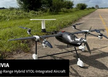 aircraft on a concrete road adjacent to a grass area