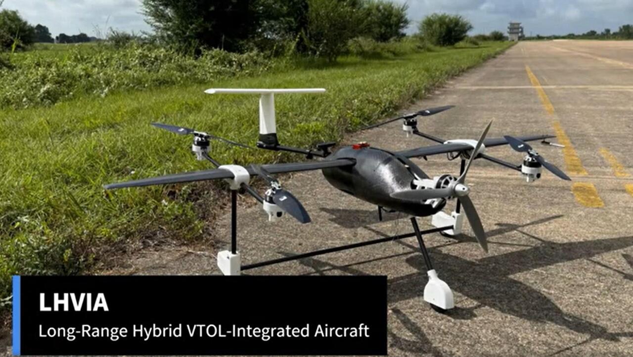 aircraft on a concrete road adjacent to a grass area