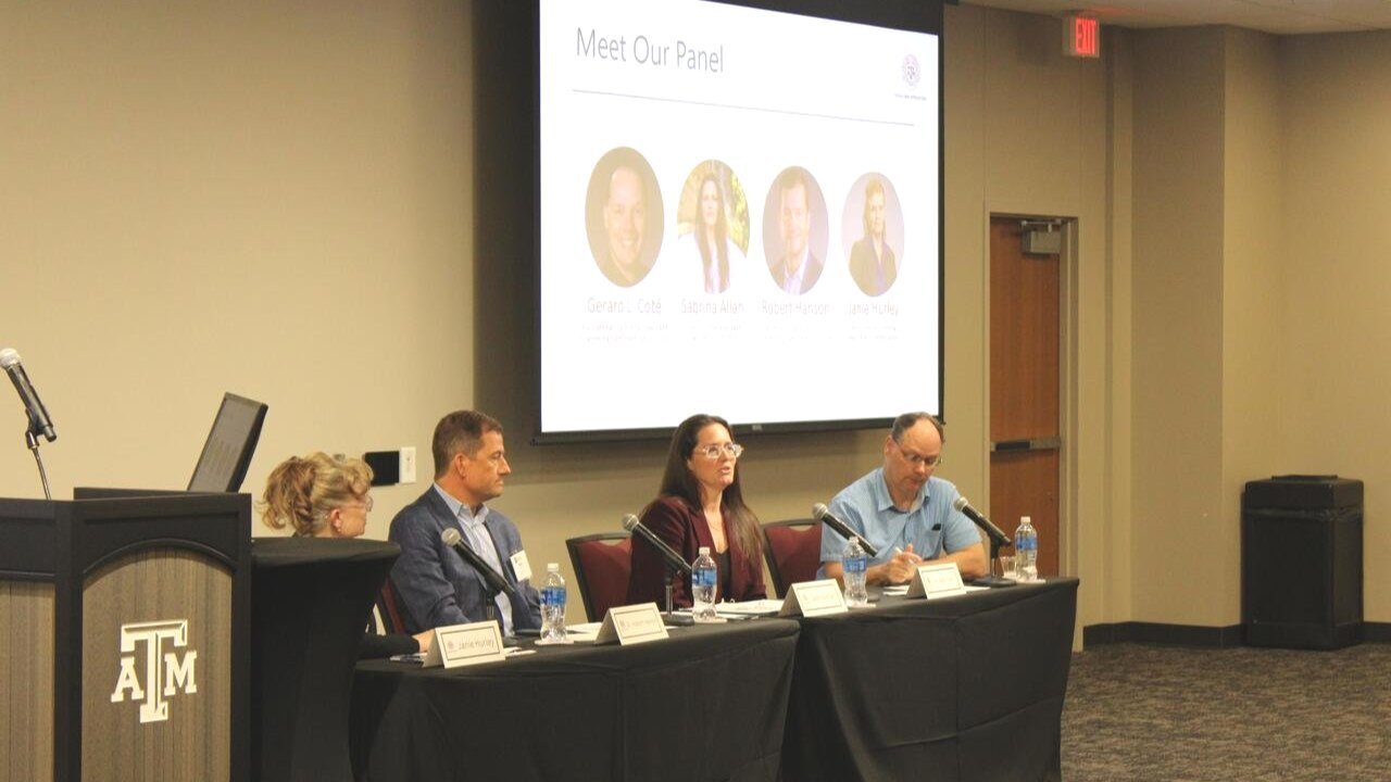 four people sitting at a table in a room