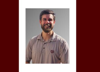 a man with a polo shirt that is smiling